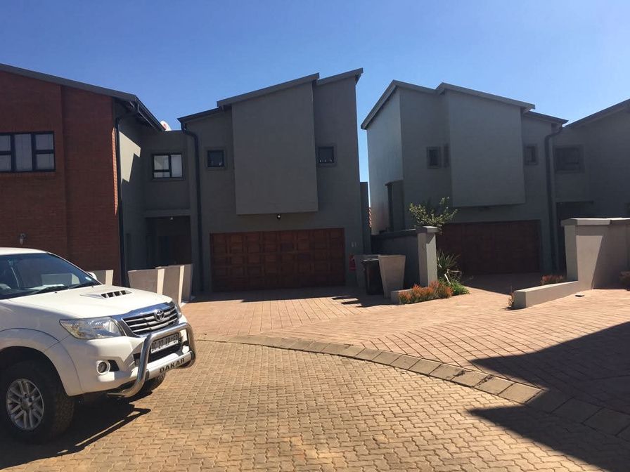 Completed double-storey townhouses around a paved courtyard in Pretoria